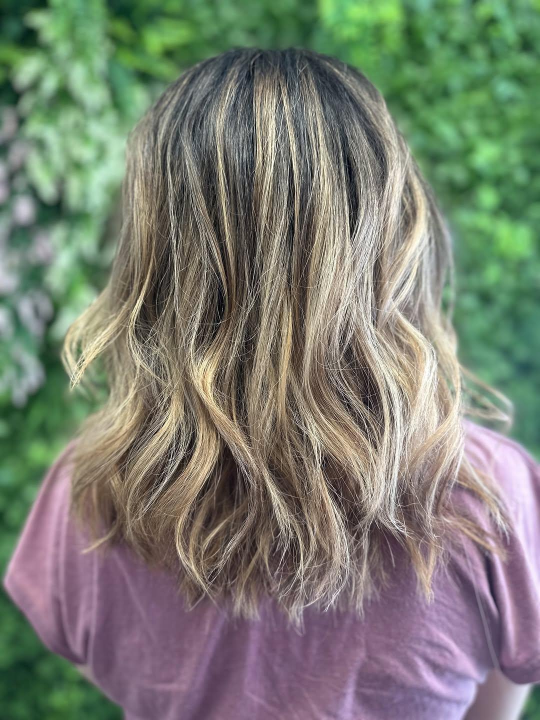 Blonde balayage over dark roots, cut to the shoulder